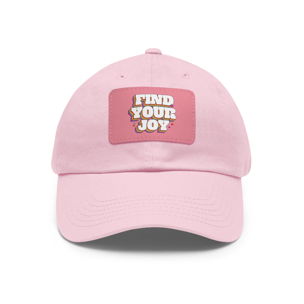 Pink twill hat with "Find Your Joy" design on a leather-like patch.